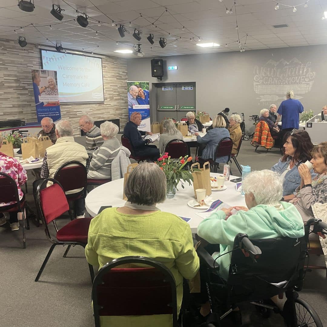 Room full of service users seated at tables during the Memory Cafe