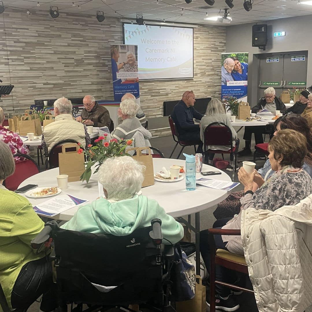 Room full of service users seated at tables during the Memory Cafe