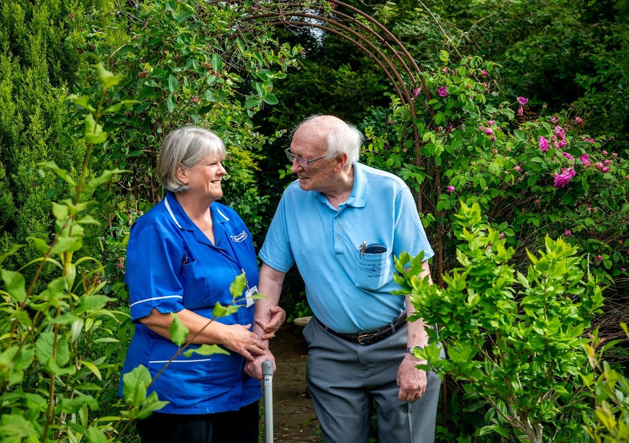 The carer as witness: caremark carer with customer in garden