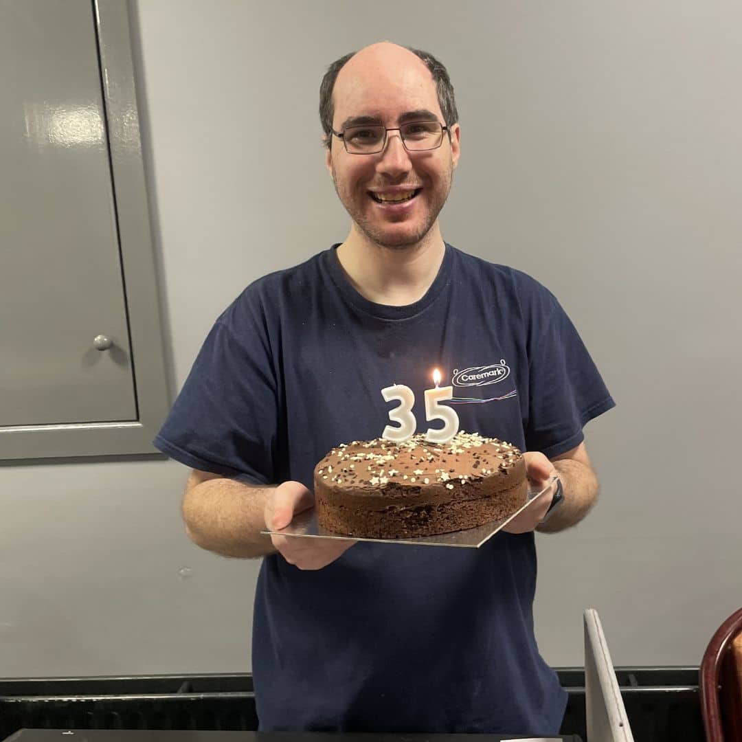 Andrew from Caremark NI celebrating his birthday with a cake at the Memory Cafe