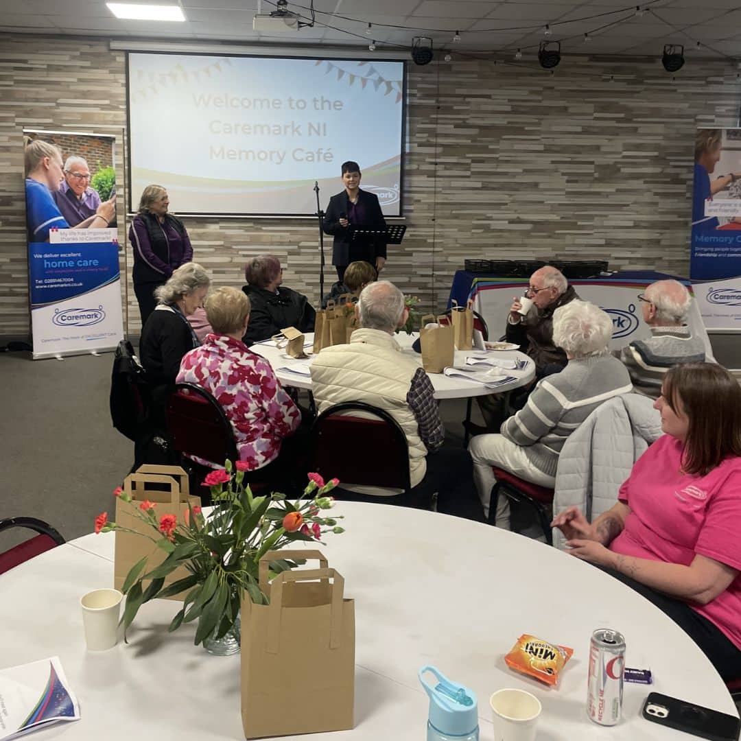 Service users sitting together around tables at the Memory Cafe