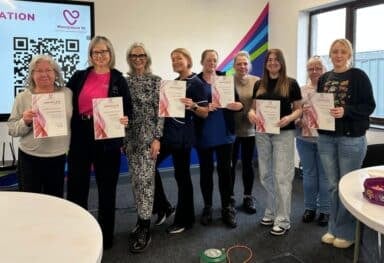Caremark NI staff pictured with Siobhan from Menopause NI holding certificates after completing menopause awareness training
