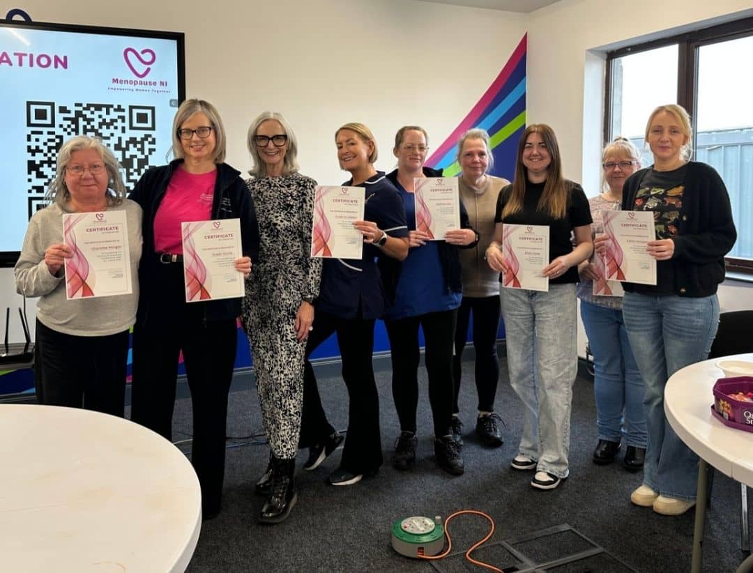 Caremark NI staff pictured with Siobhan from Menopause NI holding certificates after completing menopause awareness training
