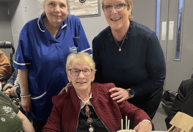 Care assistants smiling with a service user