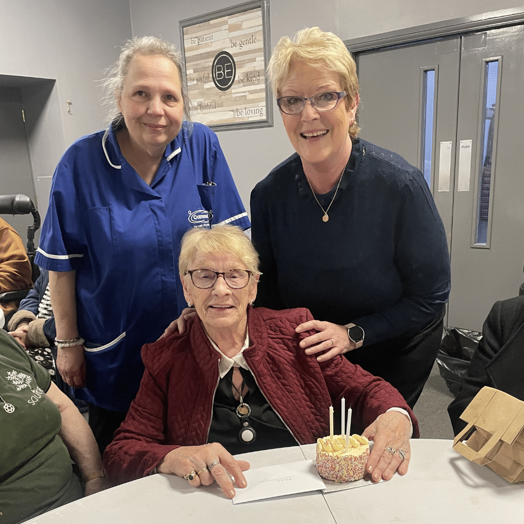 Care assistants smiling with a service user