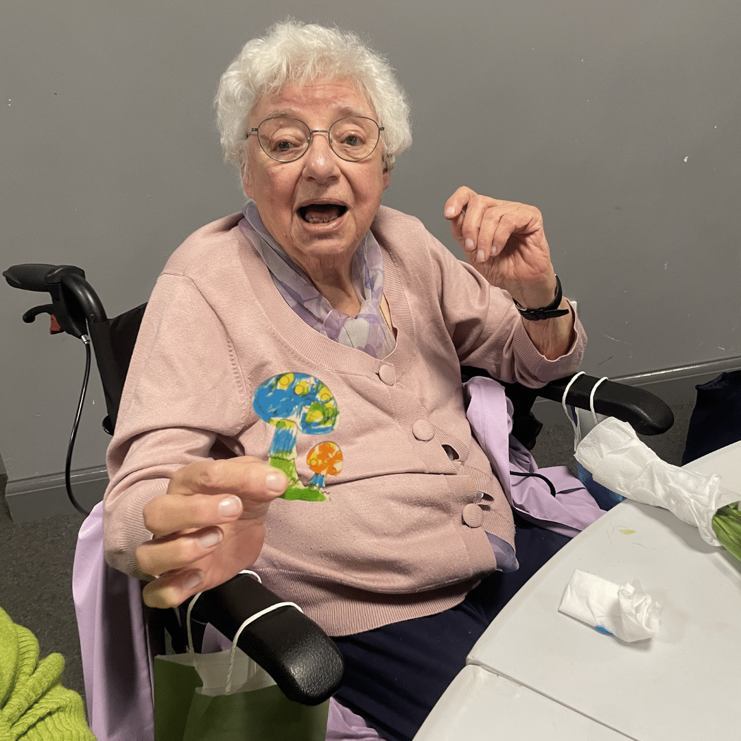 service user smiling with the art she made