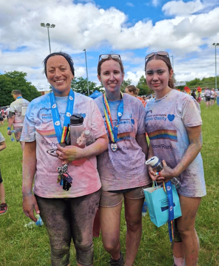 Staff and family of Caremark North Herts and Stevenage with their medals and goodie bags at Rainbow Run 2026