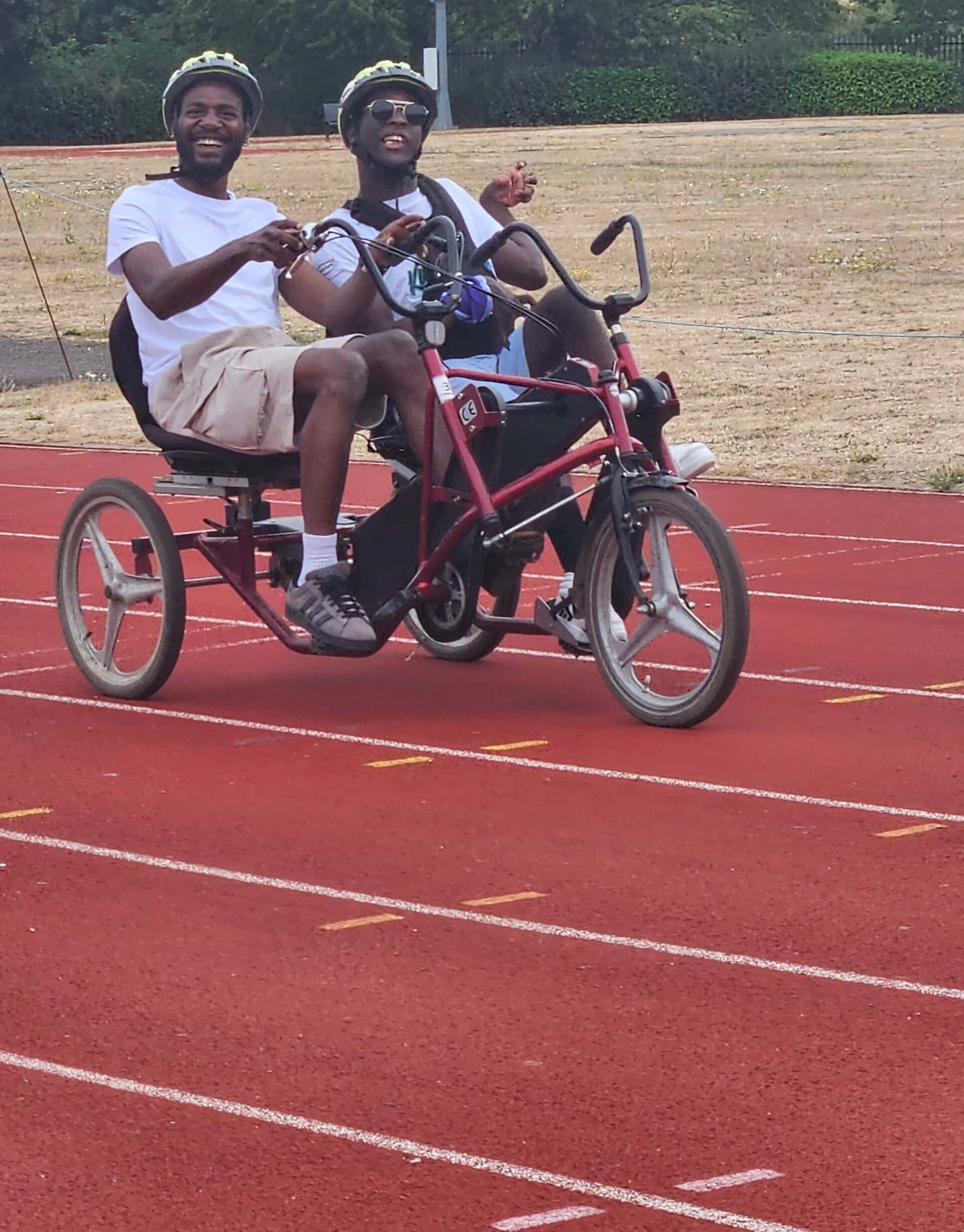 Kola and Kudzai cycling along the track at Ridlin's Stadium in Stevenage.