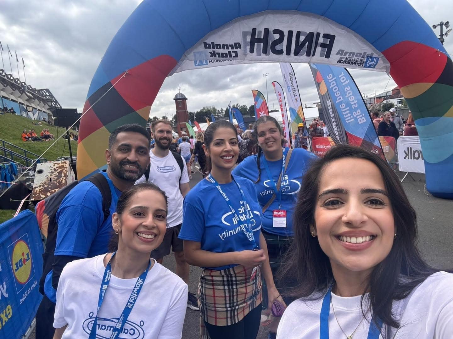 Caremark Edinburgh team crossing the Kiltwalk finish line