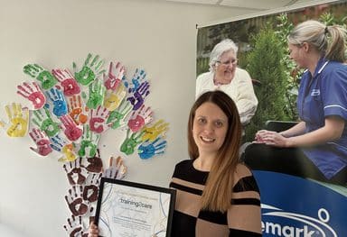 Caremark Cambridge & South Cambridgeshire receiving an Outstanding Dementia Training Award from Training 2 Care